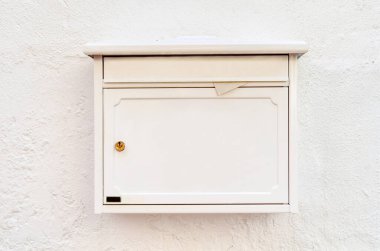 View of mailbox on white building wall clipart