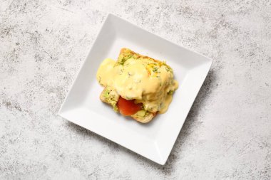 Beyaz grunge masasında nefis yumurtalı Benedict tabağı