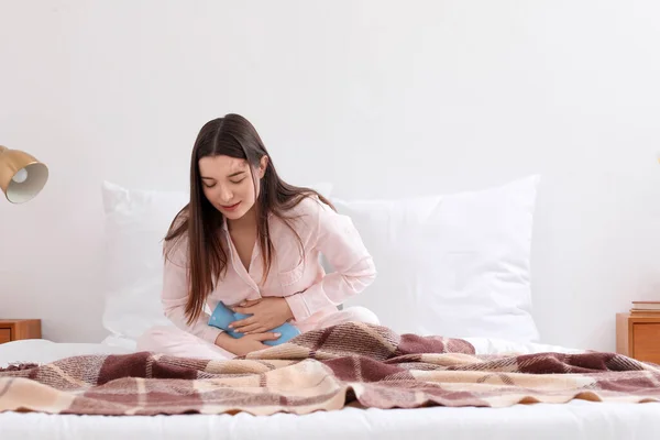 Young Woman Hot Water Bottle Suffering Menstrual Cramps Bedroom — Stock Photo, Image