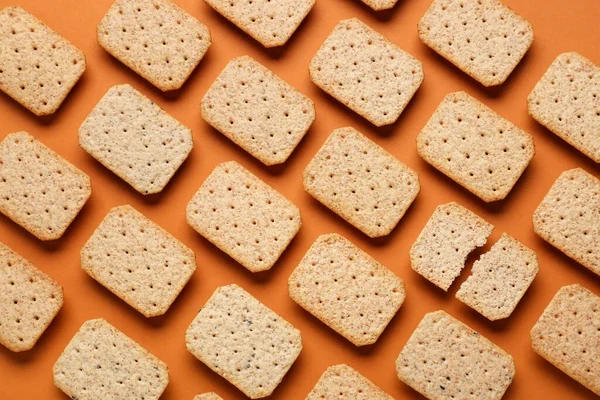 Many Tasty Crackers Orange Background Concept Uniqueness — Stock Photo, Image