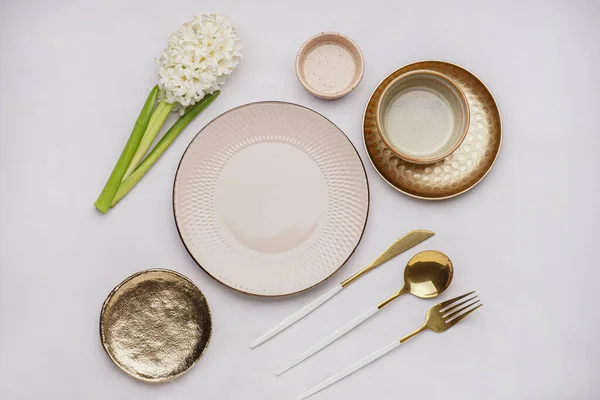 stock image Composition with clean dishes, cutlery and beautiful hyacinth flower on white background