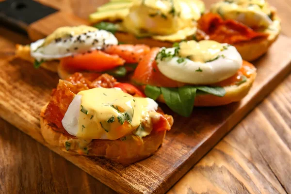 Board Different Eggs Benedict Wooden Table Closeup — Stock Photo, Image
