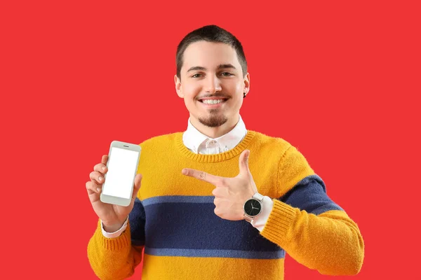 Hezký Mladý Muž Chytrým Telefonem Červeném Pozadí — Stock fotografie
