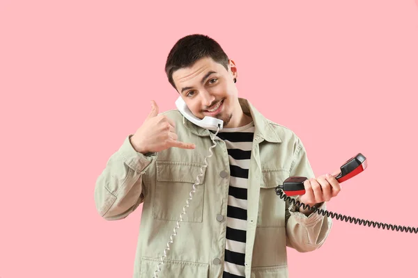 Cool Young Man Two Phone Receivers Showing Call Gesture Pink — Stock Photo, Image