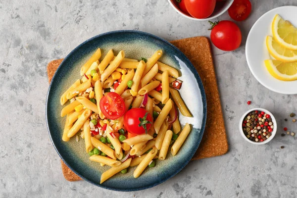 stock image Plate with tasty pasta salad on grunge background