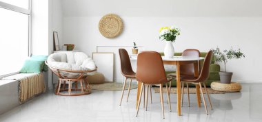 Işık odasında bir buket çiçekli yemek masası.