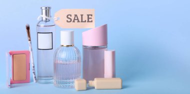 Açık mavi arka planda satılık makyaj malzemeleri