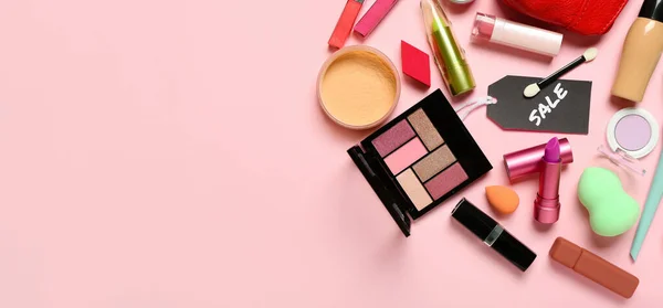 Stock image Set of makeup cosmetics and accessories for sale on pink background with space for text