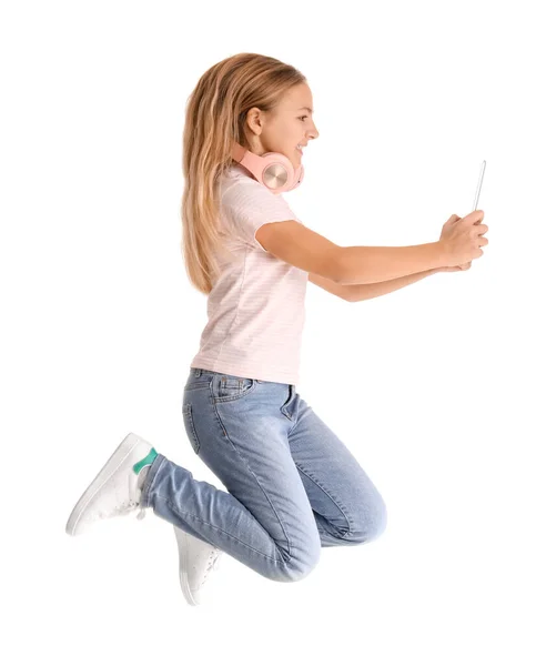 Little Girl Headphones Tablet Computer Jumping White Background — Stock Fotó