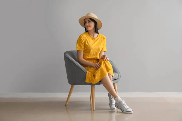 Beautiful Woman Sitting Soft Armchair Grey Wall — Stock Photo, Image