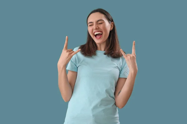 Young Woman Showing Devil Horns Blue Background — Stock Photo, Image