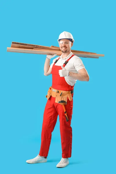 Male Carpenter Wooden Planks Showing Thumb Blue Background — Stock Photo, Image