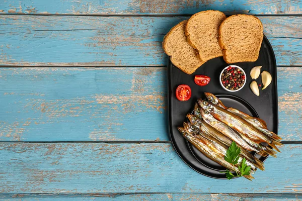 Board Tasty Smoked Capelin Bread Pieces Blue Wooden Background — Stock Photo, Image