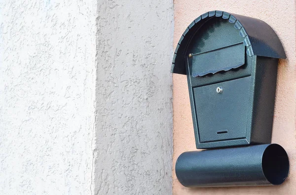 View of green mailbox on building wall