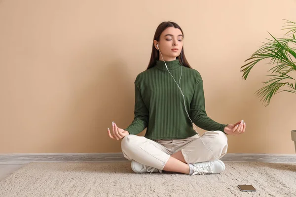 Meditating Young Woman Sitting Floor Beige Wall — Stock Photo, Image