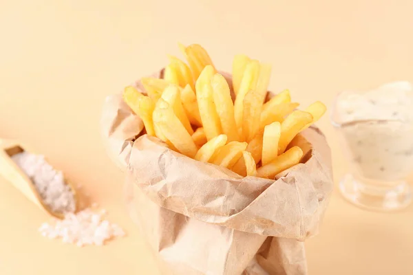 Paper Bag Tasty French Fries Salt Beige Background — Stock Photo, Image