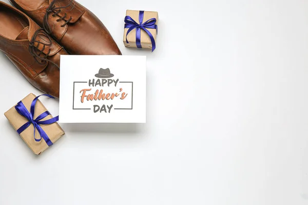 Stock image Card with text HAPPY FATHER'S DAY, stylish male shoes and gifts on white background