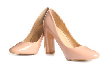 Beyaz arka planda bej renkli yüksek topuklu ayakkabılar.