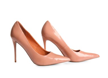 Beyaz arka planda bej renkli yüksek topuklu ayakkabılar.