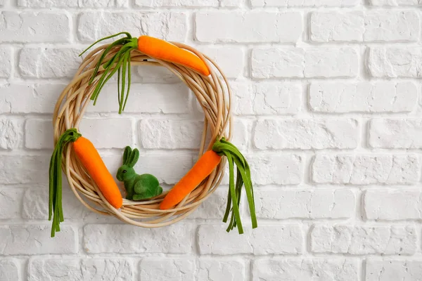 Easter wreath hanging on white brick wall