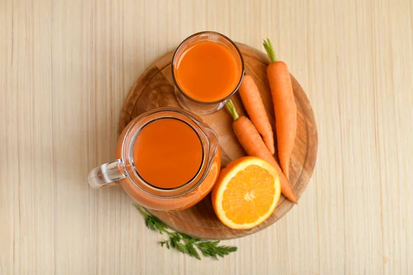 Glass Jug Fresh Carrot Juice Oranges Light Wooden Background — Stock Photo, Image