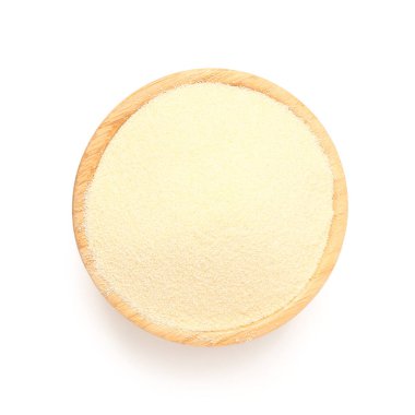 Beyaz arka planda bir kase çiğ irmik.