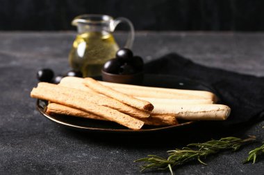 Koyu arkaplanda lezzetli İtalyan Grissini tabağı