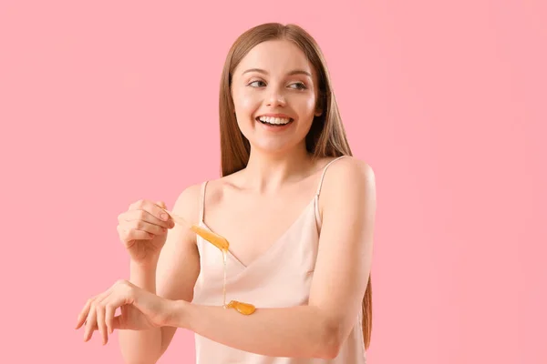 Young Woman Applying Sugaring Paste Her Arm Pink Background — Stock Photo, Image