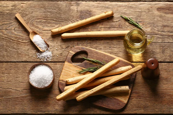 stock image Board with tasty Italian Grissini on wooden background