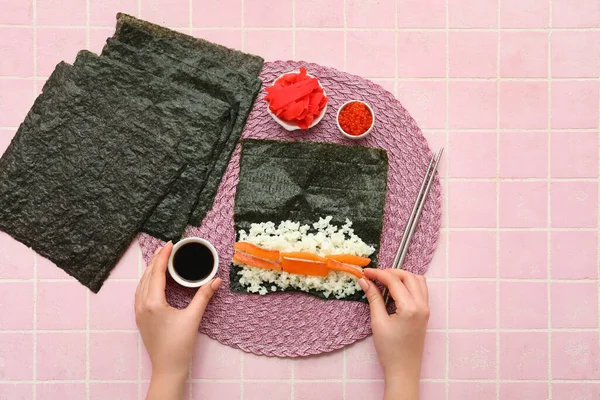 Woman Preparing Sushi Rolls Pink Tile Background — Stock Photo, Image