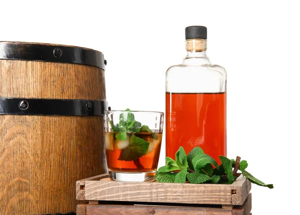 Wooden box with bottle and glass of cold rum and barrel on white background