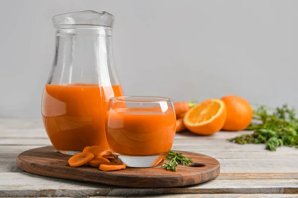 Glass Jug Fresh Carrot Juice Oranges Grey Wooden Table — Stock Photo, Image