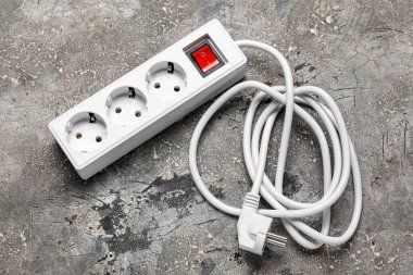 Gri grunge arka planında elektrik uzatma kablosu