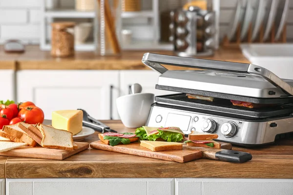 stock image Modern electric grill with sandwiches on kitchen counter