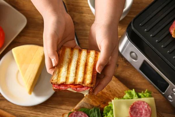 Woman Holding Delicious Sandwich Modern Electric Grill — Stock Photo, Image