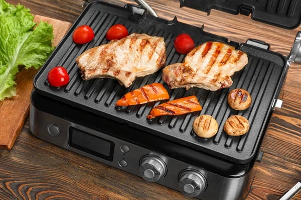 Modern Electric Grill Steaks Vegetables Wooden Background — Stock Photo, Image