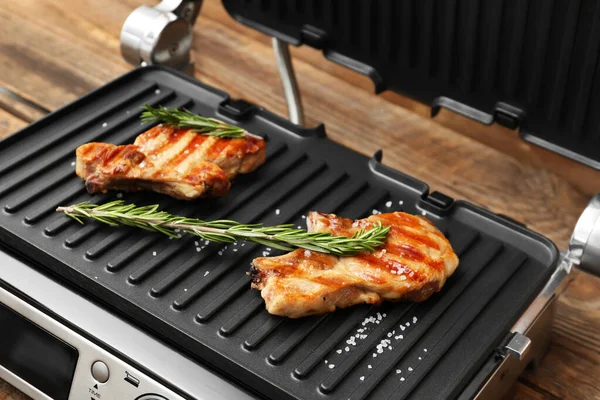 Modern Electric Grill Delicious Steaks Wooden Table Closeup — Stock Photo, Image