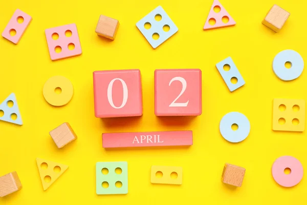 Date World Autism Awareness Day Baby Toys Yellow Background — Stock Photo, Image
