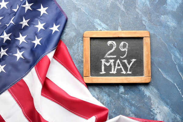 Chalkboard with date of Memorial Day and USA flag on grunge background