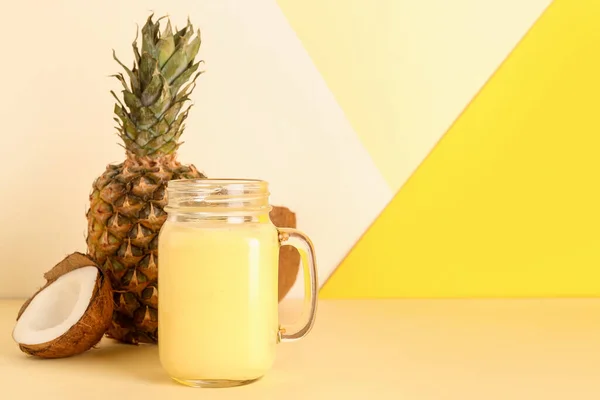 Einmachglas Mit Leckerem Ananas Smoothie Und Kokosnuss Auf Farbigem Hintergrund — Stockfoto