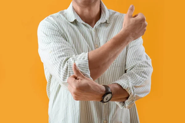 Mature Man Rolling His Sleeve Yellow Background Closeup — Stock Photo, Image