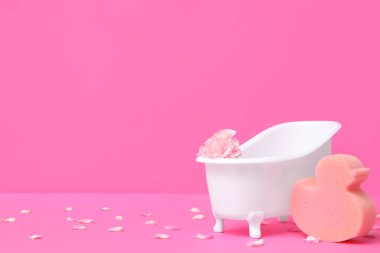 Karanfil çiçekli küçük küvet ve arka planda sünger.