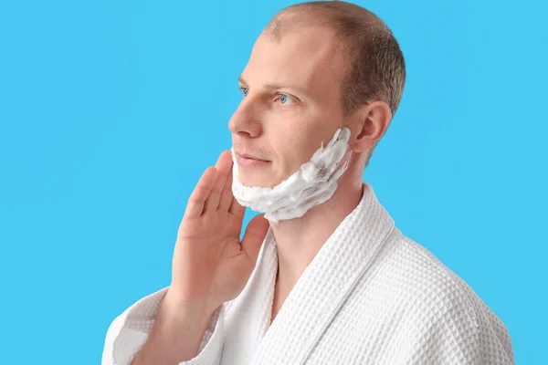 Young Man Applying Shaving Foam Face Light Blue Background — Stock Photo, Image
