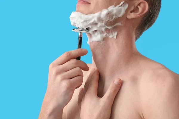 Young Man Shaving Light Blue Background Closeup — Stock Photo, Image