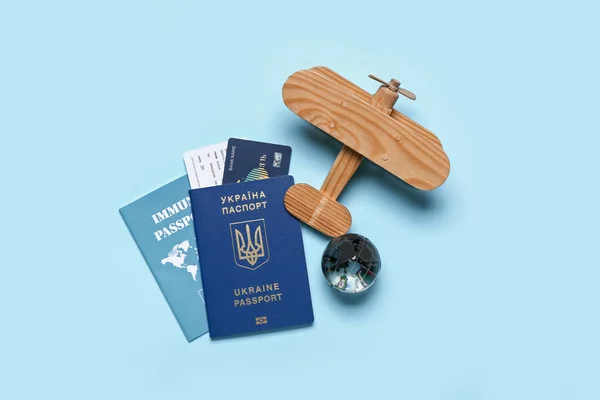 Ukrainian Immune Passports Wooden Airplane Blue Background — Stock Photo, Image