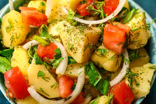 Bowl of tasty Potato Salad with vegetables, closeup