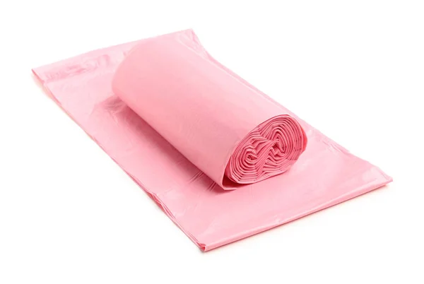 白い背景に隔離されたゴミ袋のピンクのロール — ストック写真