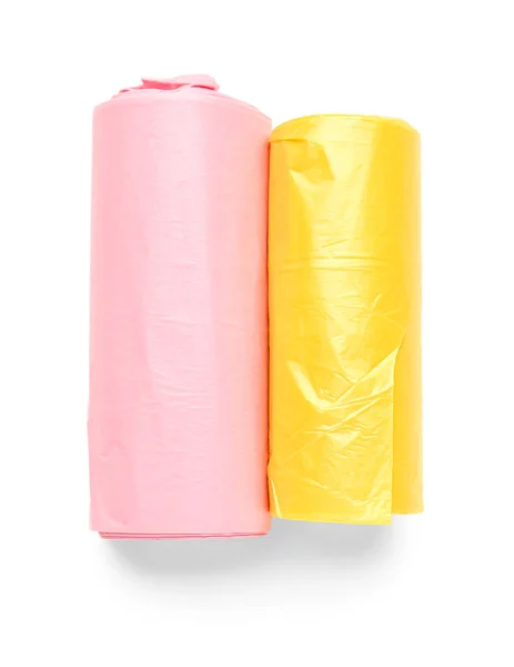 白い背景に隔離されたゴミ袋のピンクと黄色のロール — ストック写真