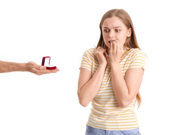 Nervous young woman get proposed on white background