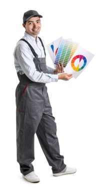Male painter with color palettes on white background